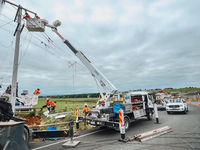 WEL Networks crew working on power lines with their Waimea Built specialist vehicles.