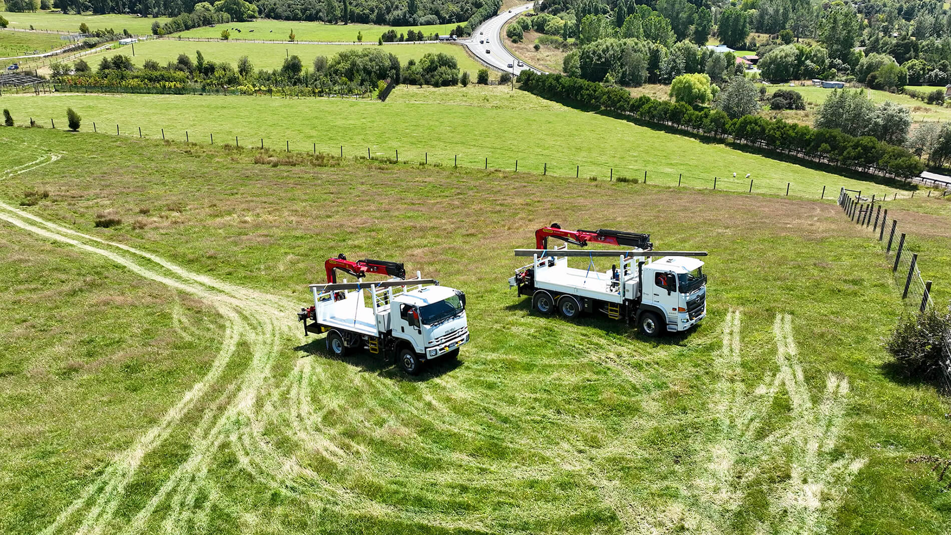 WEL Networks crew working on power lines with their Waimea Built specialist vehicles.