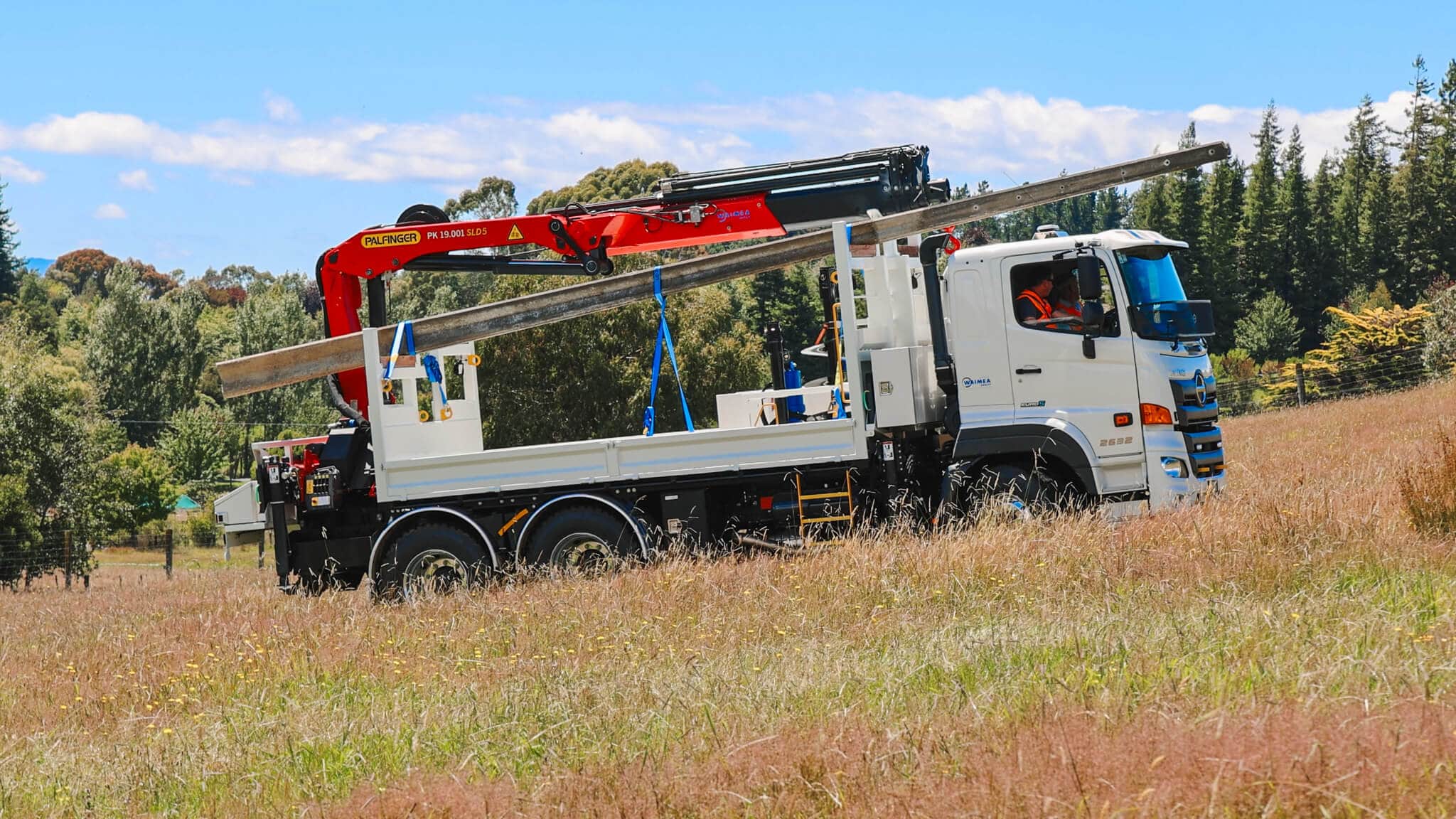 WEL Networks crew working on power lines with their Waimea Built specialist vehicles.