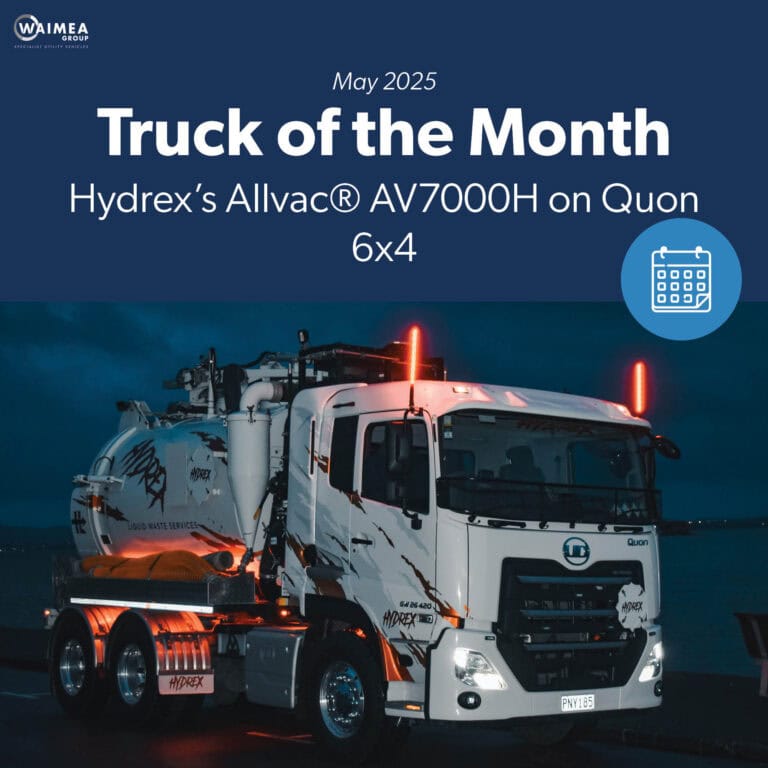 A hydro excavation truck with orange lighting on a dark night