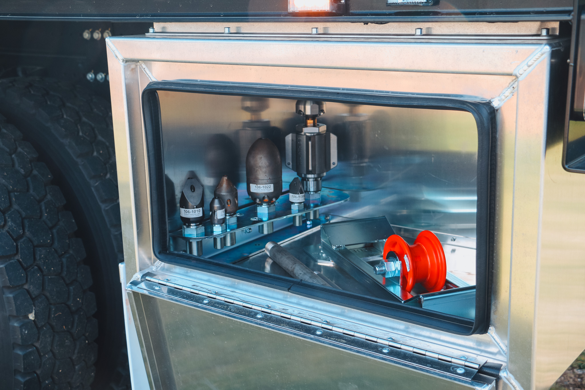 The Allvac® A6000J Jetter (2) A large jetting specialist utility truck with a large grey tank and two big hose reels of different sizes on the back, with toolboxes and other convenient features fitted.