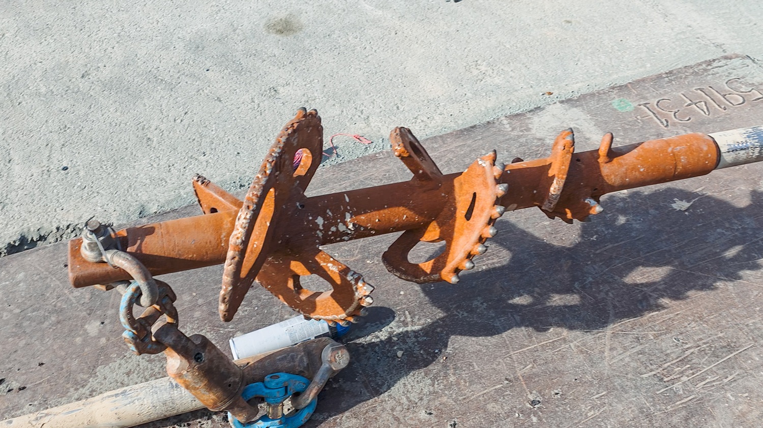A man in hi-vis gear and a hard hat standing in front of an Allvac® AV7000H hydrovac truck and other drilling equipment on a construction site