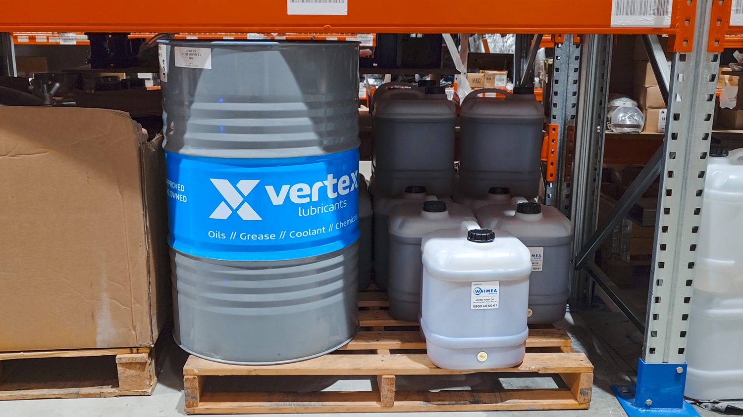 A man crouching next to a blue Moro Kaiser vacuum pump fitted on a vacuum tanker truck, talking to the camera.