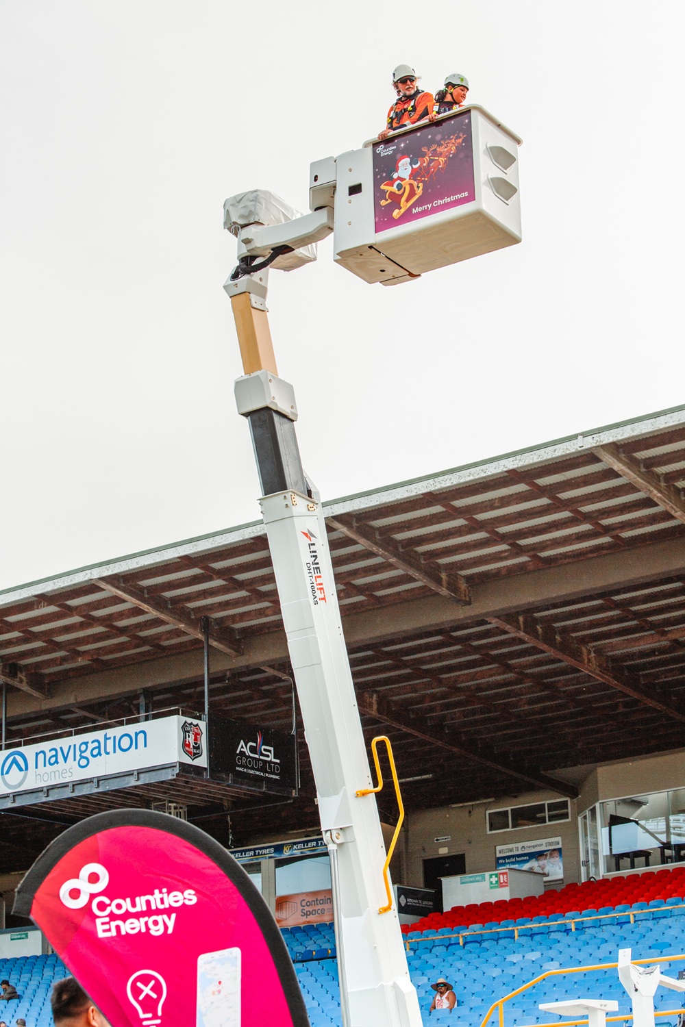 A bucket truck EWP giving rides to children advertising Counties Energy.