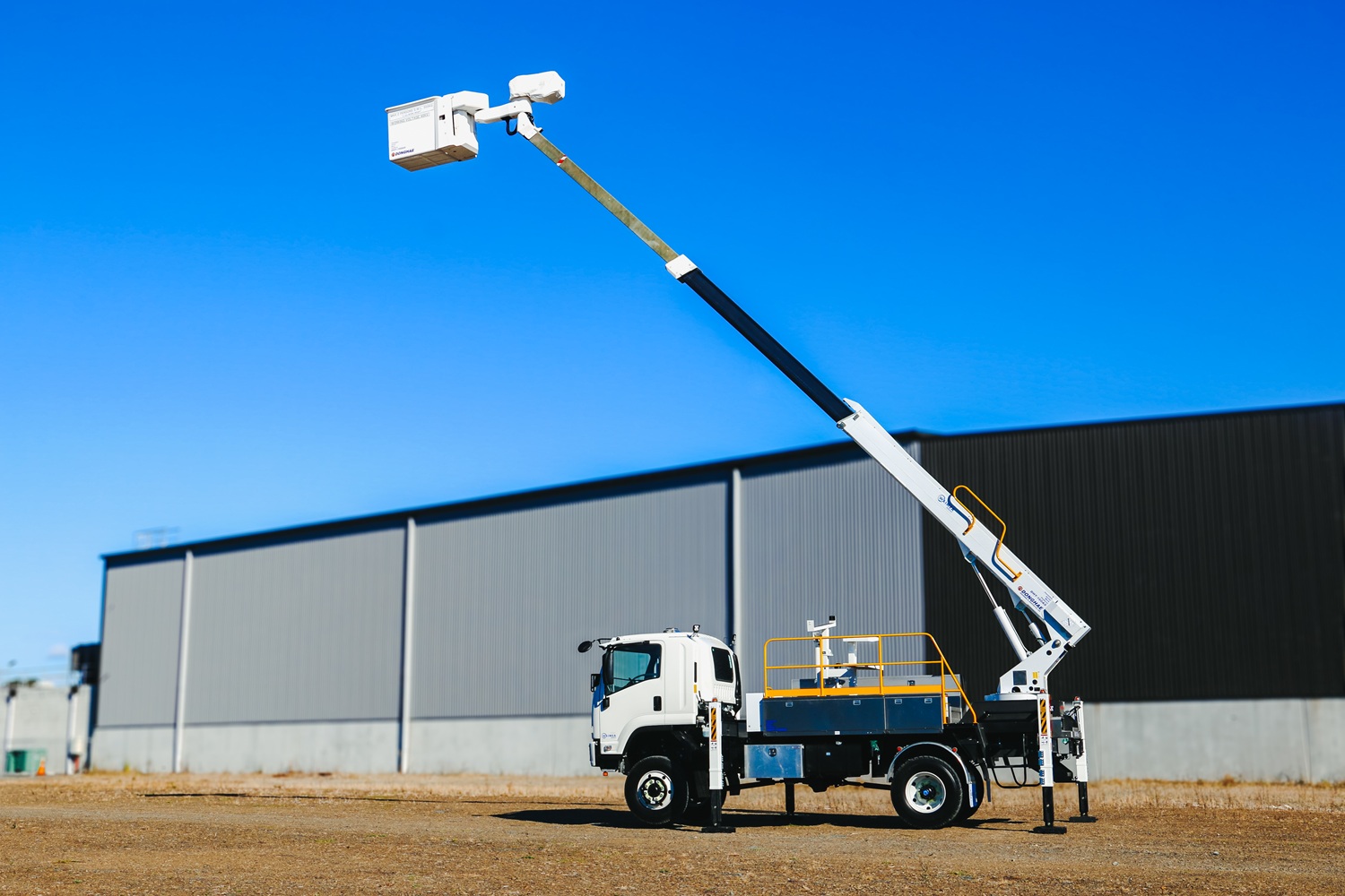 A bucket truck EWP giving rides to children advertising Counties Energy.