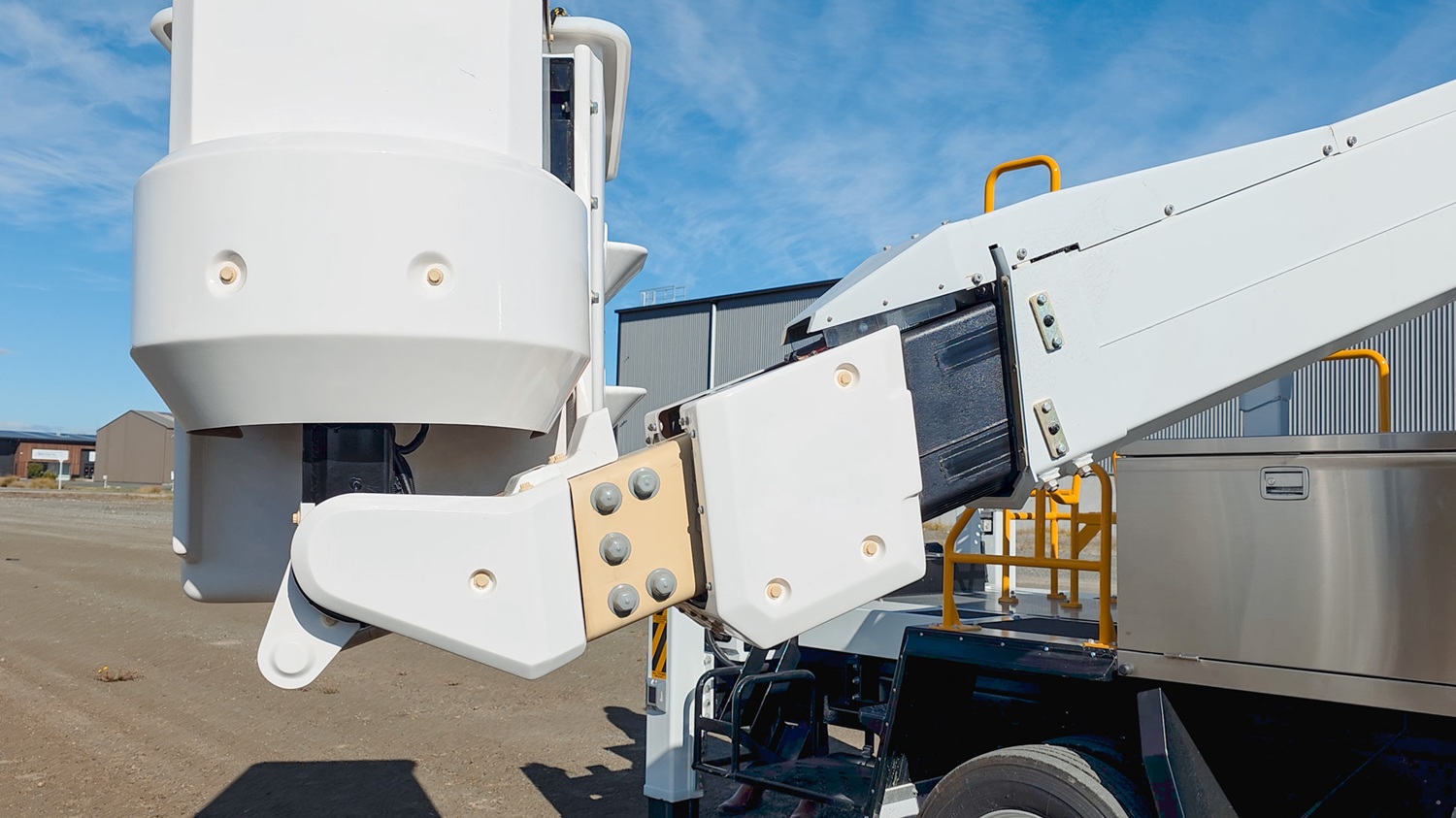 A man in a hi-vis vest stands in front of a white Linelift® bucket truck, which is parked in the background and has the boom and bucket extended into the foreground. The man is gesturing to the bucket.