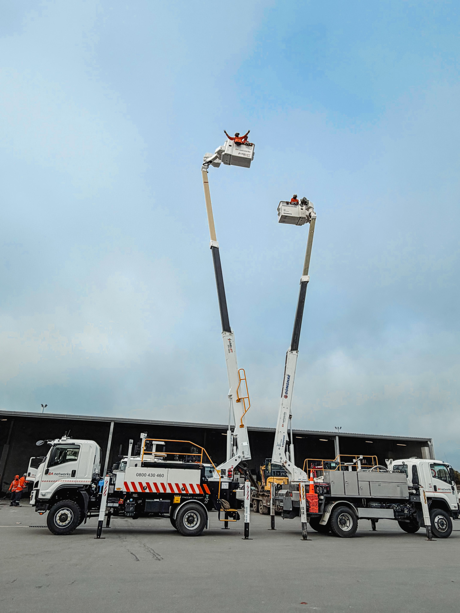 A white specialist elevated work platform truck parked on gravel, with a boom and bucket mounted on top with Linelift® branding and large toolboxes on the sides.