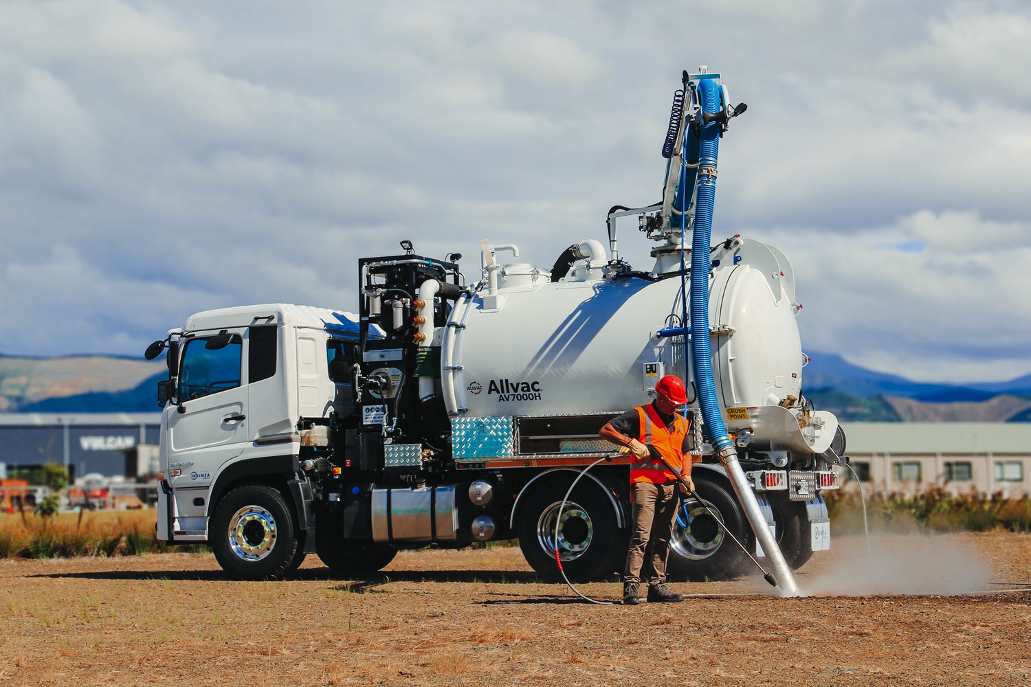 An Allvac® hydro excavation truck using a pressurised water lance and vacuum hose to expose underground pipes and cables at a New Zealand job site.